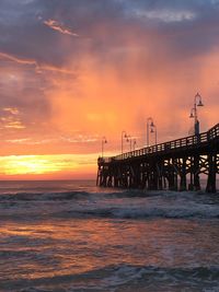 Scenic view of sea against orange sky