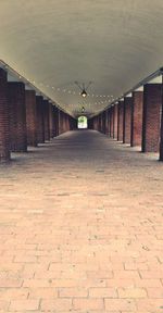 Empty footpath amidst buildings