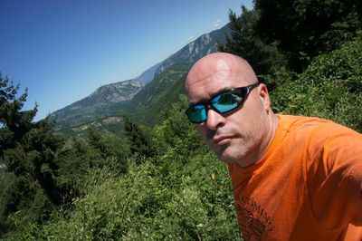 Portrait of man wearing sunglasses against sky