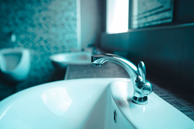 Close-up of faucet in bathroom at home