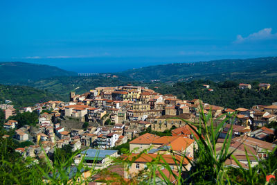 High angle view of townscape against blue sky