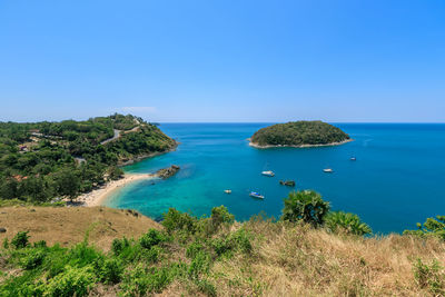 Scenic view of bay against clear blue sky