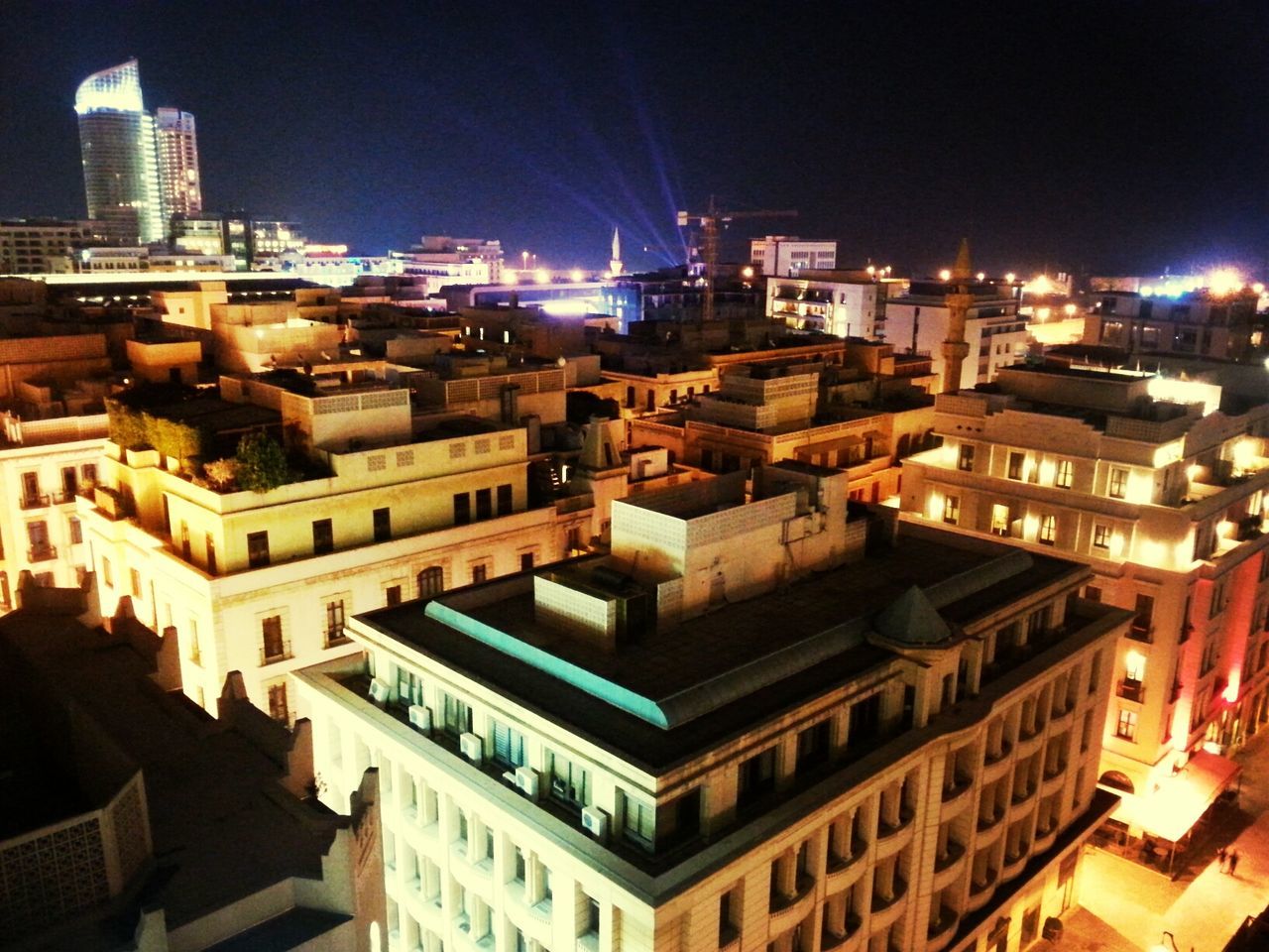 building exterior, architecture, built structure, city, illuminated, night, cityscape, residential building, residential district, crowded, residential structure, high angle view, development, city life, tower, building, skyscraper, outdoors, clear sky, roof