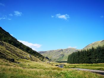 Scenic view of landscape against blue sky