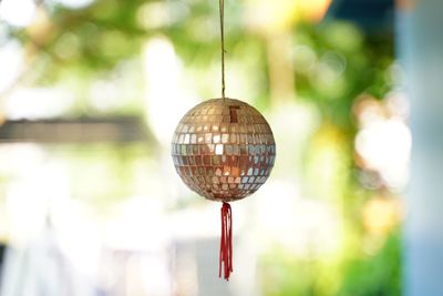 Close-up of lighting equipment hanging on glass