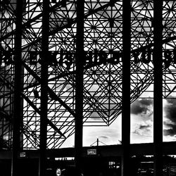 Low angle view of silhouette building against sky seen through window