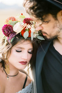 Close-up of young woman with bouquet