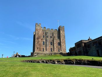 Low angle view of historical building against blue sky