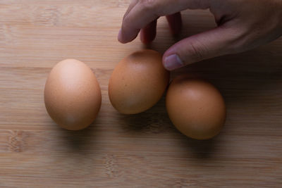 Close-up of hand holding eggs