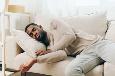 Young woman sleeping on bed at home