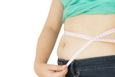 Midsection of woman standing against white background