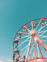 Low angle view of ferris wheel against clear blue sky