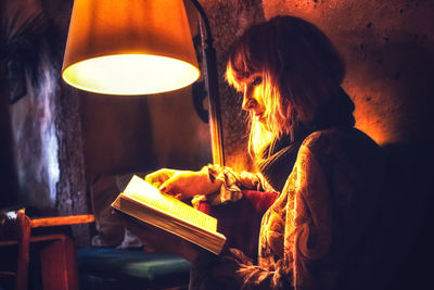 Midsection of woman holding burning candles