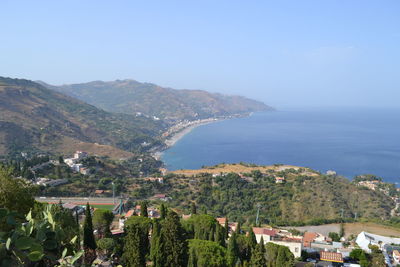 High angle view of sea and mountains against clear sky