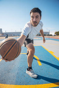 Full length portrait of young man against sky