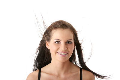 Portrait of a smiling young woman over white background