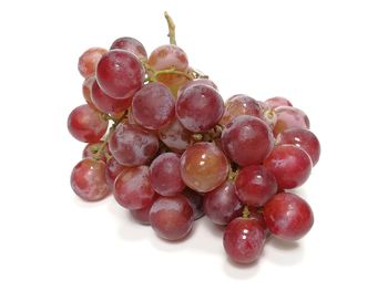 Close-up of grapes over white background