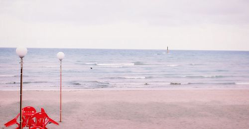 Empty table and chairs placed on beach