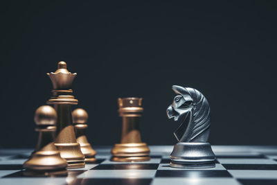 Close-up of chess pieces against black background