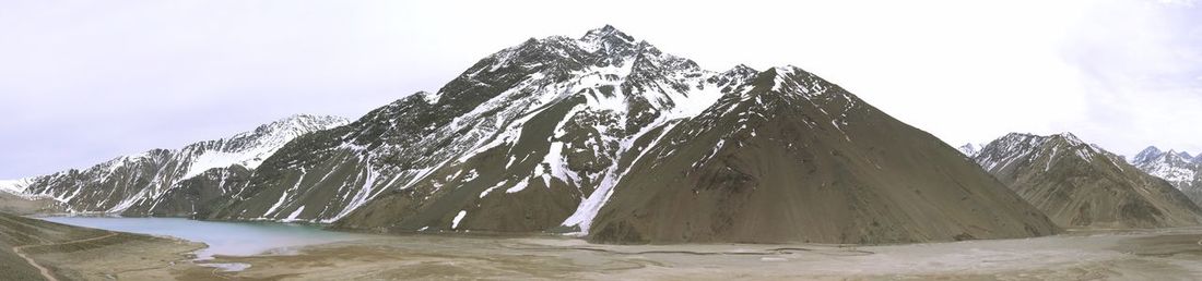 Panoramic view of snow covered mountain against sky