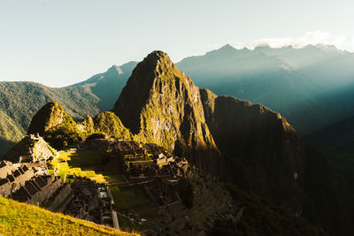 World heritage site machu picchu in peru at sunrise with sunrays on the mountain