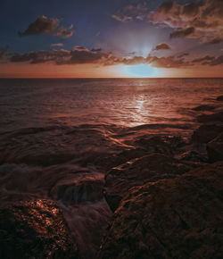 Scenic view of sea against cloudy sky