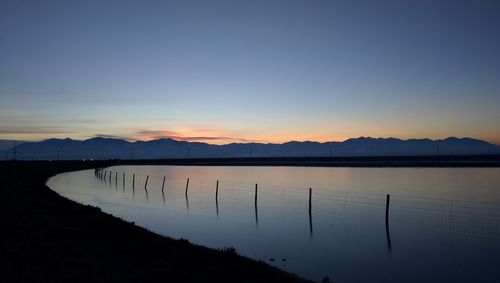 Scenic view of lake at sunset