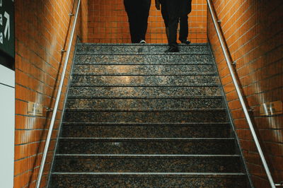 Low section of person standing on staircase