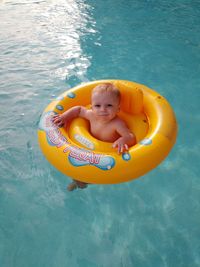 Portrait of smiling boy in swimming pool