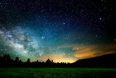 Scenic view of field against sky at night