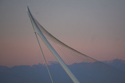 Low angle view of suspension bridge against sky during sunset