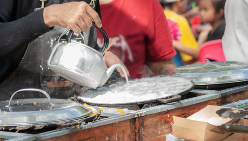 Midsection of man preparing food