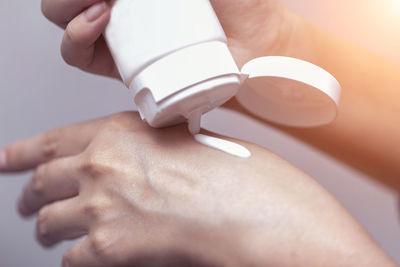 Close-up of woman applying moisturizer on hand