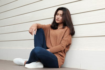 Young woman sitting outdoors