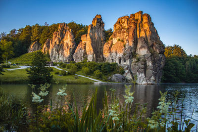 Scenic view of lake and rocks against sky