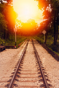 View of railroad tracks against sky during sunset