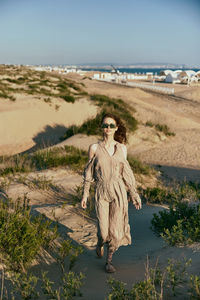 Rear view of woman standing at beach