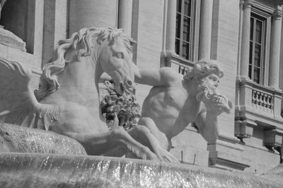 Statue against historic building