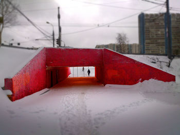 Wet red bridge against sky
