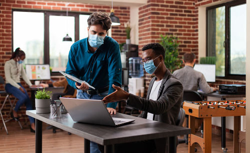 Business people wearing mask working at office