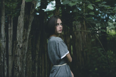 Portrait of woman standing in forest