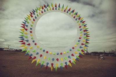 Low angle view of multi colored hanging against sky