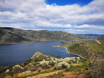 Scenic view of lake and mountains against sky