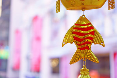 Close-up of multi colored decoration hanging outside temple