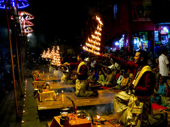 People on illuminated street at night