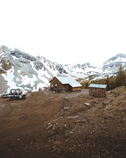 Houses on snowcapped mountain against sky