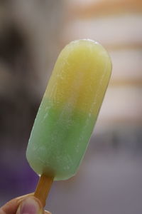 Close-up of hand holding ice cream