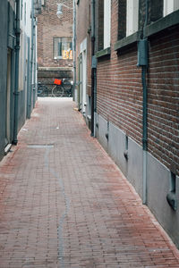 Empty alley amidst buildings in city