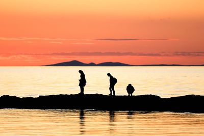 Silhouette people at sunset