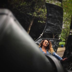 Young woman relaxing on hammock at park